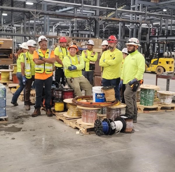 Group of Electricians in a Shop