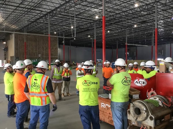 Electricians meeting on job site